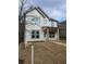 Charming two-story home featuring a covered porch, white siding, and a well-manicured front yard at 5115 N Pratt St, Covington, GA 30014