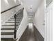 Spacious foyer with dark wood floors, staircase with metal spindles, and a well-lit entry at 5115 N Pratt St, Covington, GA 30014