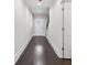 Entryway showcasing dark wood floors leading to the front door and staircase at 5115 N Pratt St, Covington, GA 30014