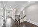 Upstairs hallway featuring dark wood floors and natural light from the window at 5115 N Pratt St, Covington, GA 30014