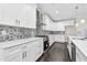 Well-appointed kitchen featuring modern appliances, custom cabinets, quartz countertops, and an eye-catching backsplash at 5115 N Pratt St, Covington, GA 30014