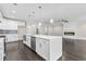 Modern kitchen boasts quartz island, stainless appliances, and an open layout with fireplace view at 5115 N Pratt St, Covington, GA 30014