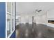 Open-concept living room featuring dark hardwood floors, a fireplace, and an adjoining kitchen with white cabinetry at 5115 N Pratt St, Covington, GA 30014