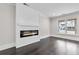Inviting living room showcasing a modern fireplace, shiplap accent wall, and large window with natural light at 5115 N Pratt St, Covington, GA 30014