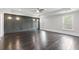 Stunning main bedroom with tray ceiling, hardwood floors, custom wall trim, and large windows at 5115 N Pratt St, Covington, GA 30014