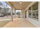 Covered porch with concrete flooring, column supports, recessed lighting, and a view of the landscaped front yard at 5115 N Pratt St, Covington, GA 30014