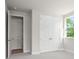 Bedroom with neutral walls and plush carpet, showing a double door closet at 910 Melody Ridge Ln, Buford, GA 30518