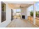 Covered back porch features an outdoor fireplace, ceiling fan, and wooden decking and railing at 2711 Twisted Oak Ne Ln, Marietta, GA 30066