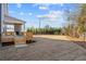 Spacious backyard with a newly seeded lawn, a covered porch, and mature trees at 2711 Twisted Oak Ne Ln, Marietta, GA 30066