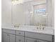 Bathroom featuring a double vanity with gray cabinets, quartz countertop, and a glass-enclosed shower at 2711 Twisted Oak Ne Ln, Marietta, GA 30066