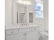 Bright bathroom features a large mirror, a white vanity, and gold colored hardware at 2711 Twisted Oak Ne Ln, Marietta, GA 30066
