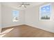 Bedroom with two windows allowing natural light, ceiling fan, and hardwood floors at 2711 Twisted Oak Ne Ln, Marietta, GA 30066
