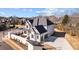 Side view of the white house with dark roof, trimmed bushes, and a long driveway at 2711 Twisted Oak Ne Ln, Marietta, GA 30066