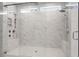 Modern tiled shower featuring dual shower heads, seating, and glass door at 2711 Twisted Oak Ne Ln, Marietta, GA 30066