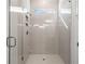 Modern bathroom shower with glass door, rainfall shower head, and tiled walls at 2711 Twisted Oak Ne Ln, Marietta, GA 30066