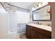 Bathroom featuring large, framed mirror, dark vanity and shower/tub combination at 5485 Brookstone Nw Dr, Acworth, GA 30101
