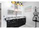 This bathroom features dual sink vanity, decorative mirrors, and elegant lighting fixtures at 5485 Brookstone Nw Dr, Acworth, GA 30101