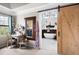 Bedroom with barn door leading to bathroom, vanity, and large window with natural light at 5485 Brookstone Nw Dr, Acworth, GA 30101