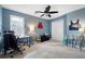 Cozy bedroom with blue walls, ceiling fan, and a comfortable workspace at 5485 Brookstone Nw Dr, Acworth, GA 30101