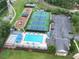 Aerial shot of a community pool area with tennis courts and a playground at 5485 Brookstone Nw Dr, Acworth, GA 30101