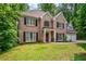Charming two-story brick home with a manicured lawn and mature trees at 5485 Brookstone Nw Dr, Acworth, GA 30101