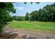 Scenic view of the golf course with lush green grass and mature trees at 5485 Brookstone Nw Dr, Acworth, GA 30101