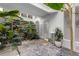 Bright, airy atrium with beautiful stone floors and featuring an array of lush, green plants at 11260 Houze Rd, Roswell, GA 30076