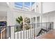 Second story view of the atrium featuring beautiful plantings, skylights, and wood floors at 11260 Houze Rd, Roswell, GA 30076