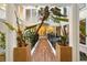 Interior atrium showcasing thriving plants, black iron railings, and abundant natural light at 11260 Houze Rd, Roswell, GA 30076