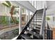 Interior home atrium with stairs, balconies, and lush plants at 11260 Houze Rd, Roswell, GA 30076