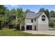 Rear exterior with outdoor deck, spacious garage, and round window detailing at 11260 Houze Rd, Roswell, GA 30076