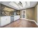 Elegant bar featuring honeycomb backsplash, white cabinets, and a beverage cooler at 11260 Houze Rd, Roswell, GA 30076