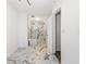 Modern bathroom featuring a marble floor, white walls, and a stand-up glass shower enclosure at 11260 Houze Rd, Roswell, GA 30076