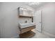 Modern bathroom with floating vanity, stylish mirror, and contemporary lighting fixtures at 11260 Houze Rd, Roswell, GA 30076