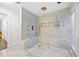 Luxurious bathroom featuring a marble shower with gold fixtures, a built-in bench, and elegant design at 11260 Houze Rd, Roswell, GA 30076