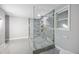 Modern bathroom featuring a glass shower enclosure with gold hardware and gray tiled walls at 11260 Houze Rd, Roswell, GA 30076