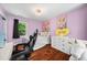 Cozy bedroom with hardwood floors, artwork and a playful stuffed animal at 11260 Houze Rd, Roswell, GA 30076