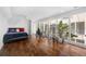 Bright bedroom features hardwood floors, an atrium view, and a modern ceiling fan at 11260 Houze Rd, Roswell, GA 30076