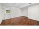 Bedroom with hardwood floors and a view into the Primary bath with marble floors at 11260 Houze Rd, Roswell, GA 30076