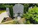 Stunning home with modern architectural design surrounded by mature trees and lush landscaping at 11260 Houze Rd, Roswell, GA 30076