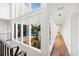 Upstairs hallway overlooking the interior courtyard with many windows and plants at 11260 Houze Rd, Roswell, GA 30076