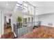 Open hallway with hardwood floors and views of the bright atrium and skylights at 11260 Houze Rd, Roswell, GA 30076