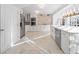 Modern kitchen with white cabinetry, stainless steel appliances, marble backsplash, and ample counter space at 11260 Houze Rd, Roswell, GA 30076