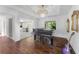 Stunning living room with wood floors, piano, elegant chandelier and lots of light at 11260 Houze Rd, Roswell, GA 30076