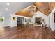 Open living room showcasing vaulted wood ceiling, fireplace, and hardwood flooring at 11260 Houze Rd, Roswell, GA 30076