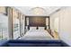 Cozy main bedroom with a chandelier, neutral color palette, and large windows for natural light at 11260 Houze Rd, Roswell, GA 30076