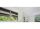 Bright interior shot showcasing windows with views of lush greenery and natural light at 11260 Houze Rd, Roswell, GA 30076