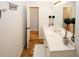 Bright bathroom featuring a white vanity and plenty of counter space with two decorative tree plants at 139 6Th St, Auburn, GA 30011