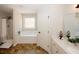 A relaxing bathroom with a tub, shower, and decorative accents, offering a soothing retreat at 139 6Th St, Auburn, GA 30011
