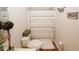 Cozy bathroom with vinyl flooring, striped shower curtain and decorative wall art and foliage at 139 6Th St, Auburn, GA 30011